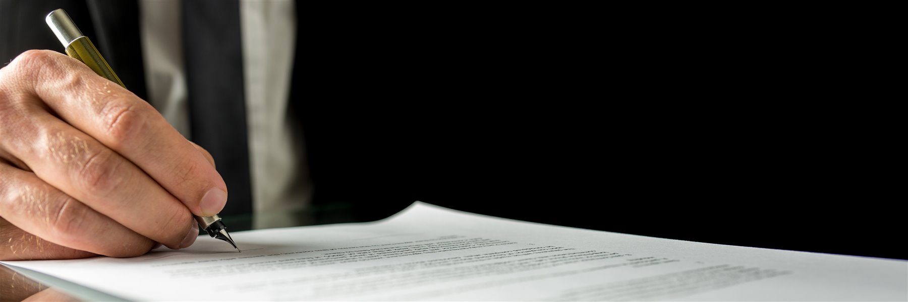 A closing professional signing transaction documents